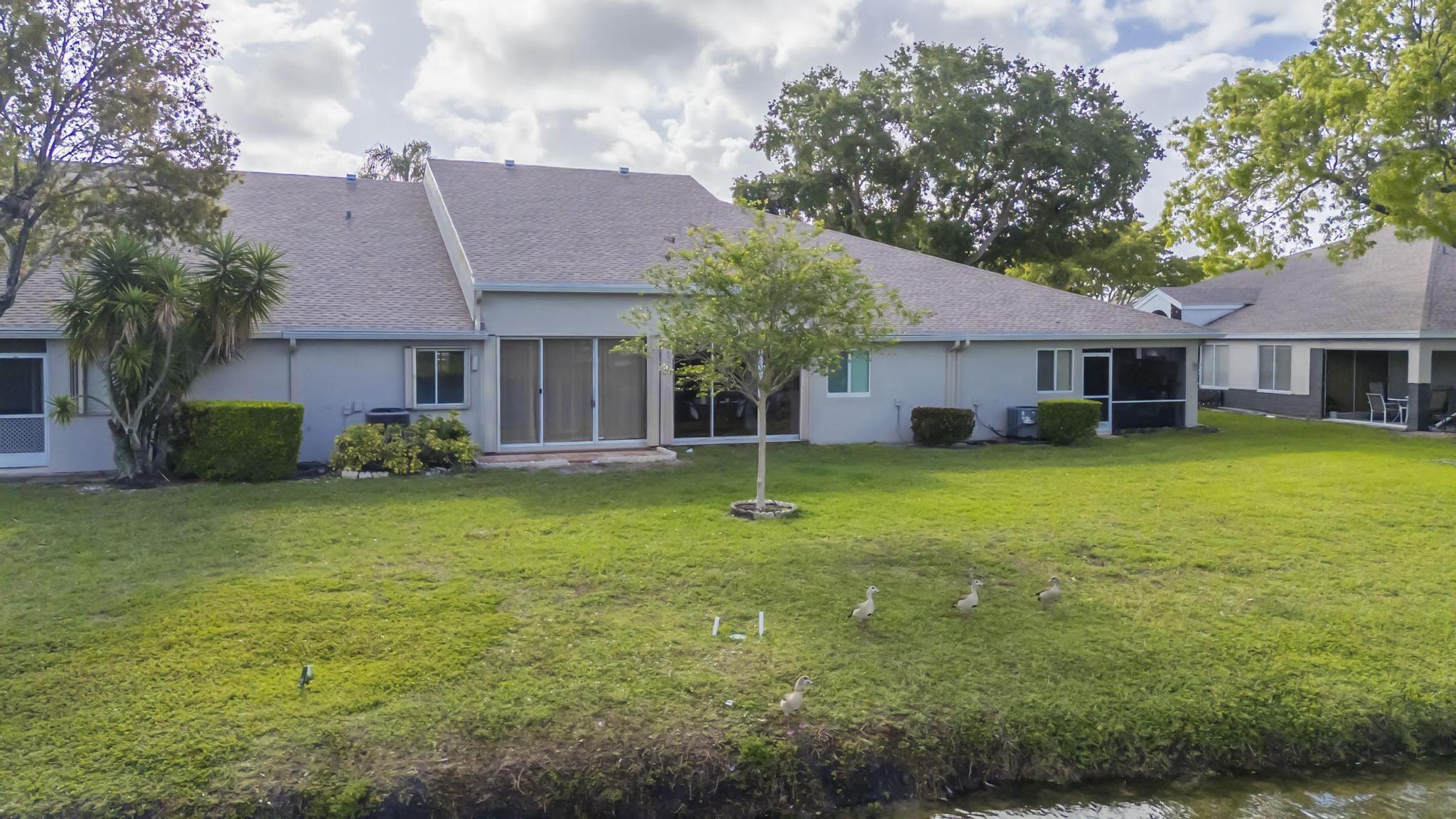 9130 Vineland Court, Unit C Boca Raton, FL 33496 - Photo 69 of 81 a view of a house with a yard porch and sitting area