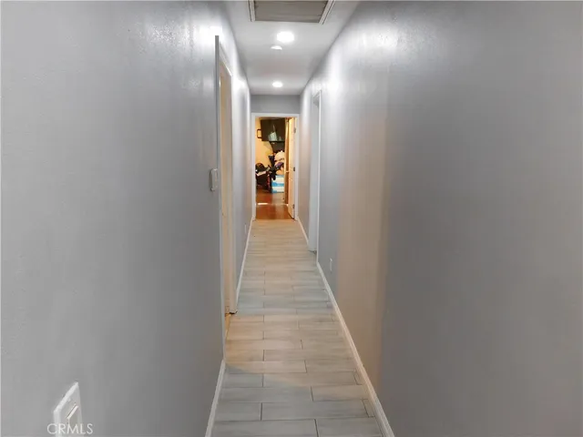a view of a hallway with wooden floor