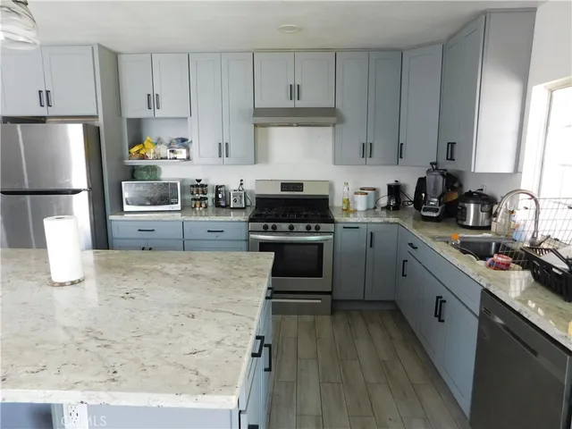 a kitchen with a stove a sink and a refrigerator