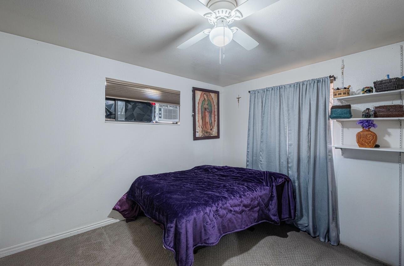 11521 Hidden Hills Road Carmel Valley, CA 93924 - Photo 18 of 26 a bedroom with a bed and a chandelier