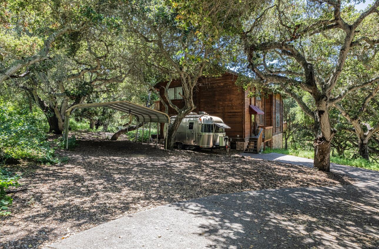 11521 Hidden Hills Road Carmel Valley, CA 93924 - Photo 6 of 26 a view of a wooden house with a large tree