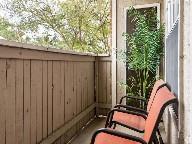 a view of a backyard with a chair and a potted plant