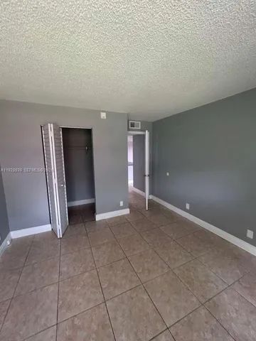 a view of an empty room and closet area