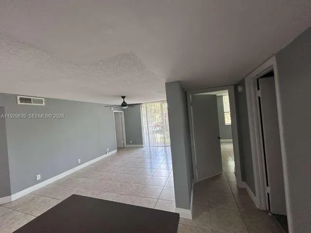 a view of a hallway with wooden shelves