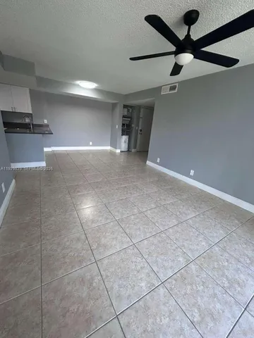 a view of a livingroom with a furniture and a ceiling fan
