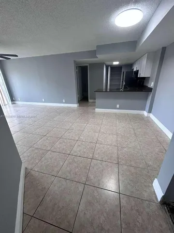 a view of a kitchen with a sink and cabinets