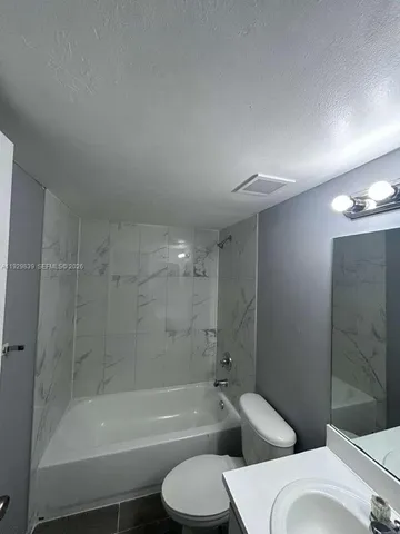 a bathroom with a toilet and a bathtub