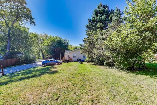 a backyard of a house with yard and trampoline
