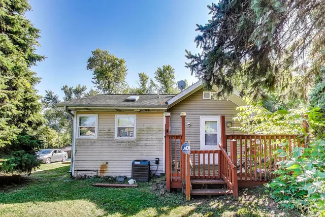 a view of a house with a small yard and wooden fence
