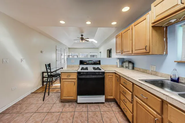 a kitchen with stainless steel appliances granite countertop a stove a sink and a refrigerator