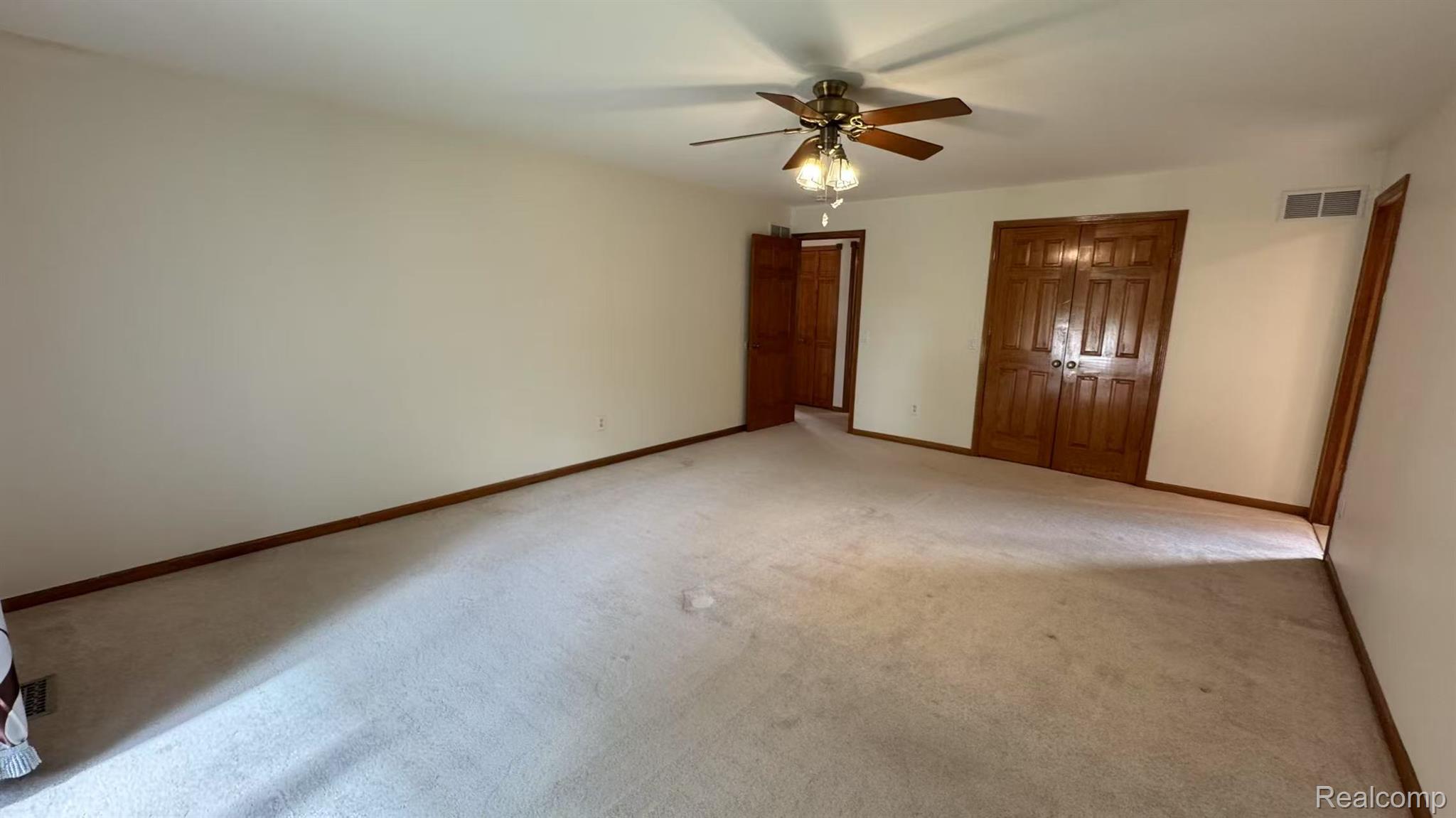 3440 Salem Drive Rochester, MI 48306 - Photo 29 of 33 Spacious room featuring neutral carpeting, light-toned walls, and wood-finish trim