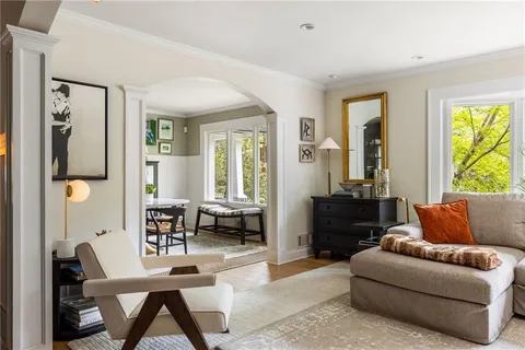 a view of a livingroom with a fireplace and workspace