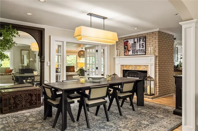 a kitchen with stainless steel appliances granite countertop a sink a stove and a wooden floor