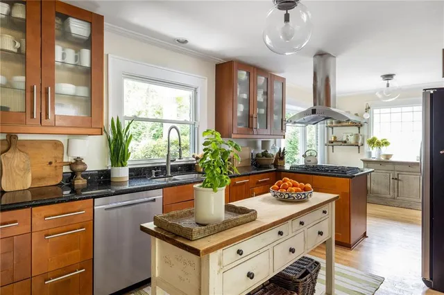 a living room with furniture a window and a potted plant