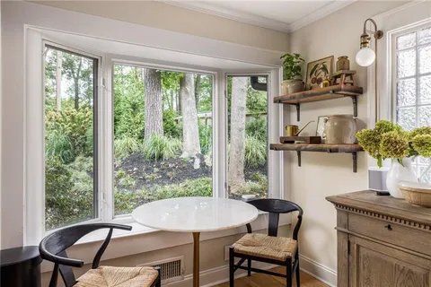 a dining room with furniture and a window