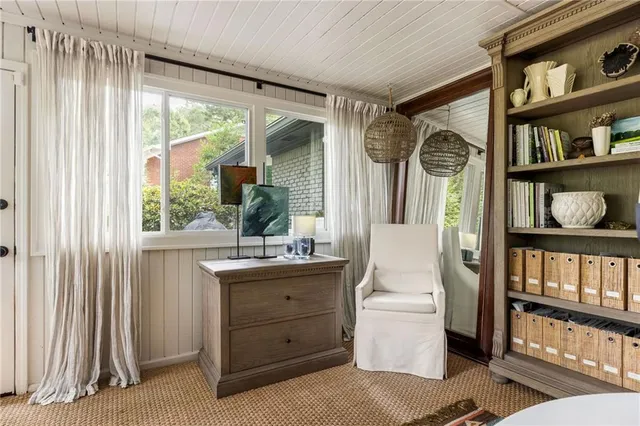 a bathroom with a granite countertop sink a toilet a mirror a bathtub and next to a window