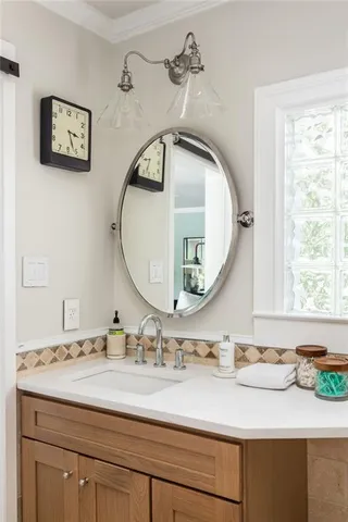 a patio with patio a table and chairs under an umbrella with large trees