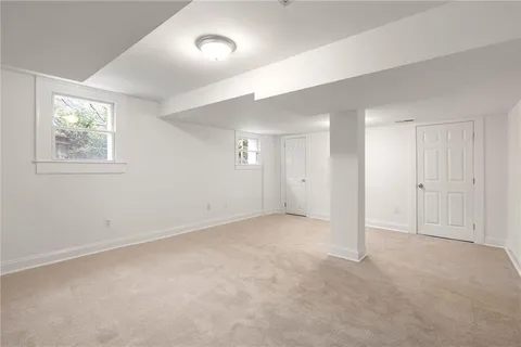 a view of a house with backyard swimming pool and sitting area
