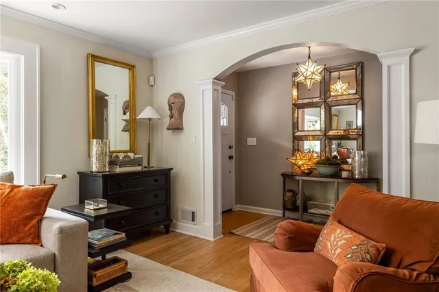a living room with furniture a window and a chandelier
