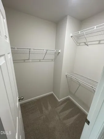 a view of storage and utility room with racks on the wall