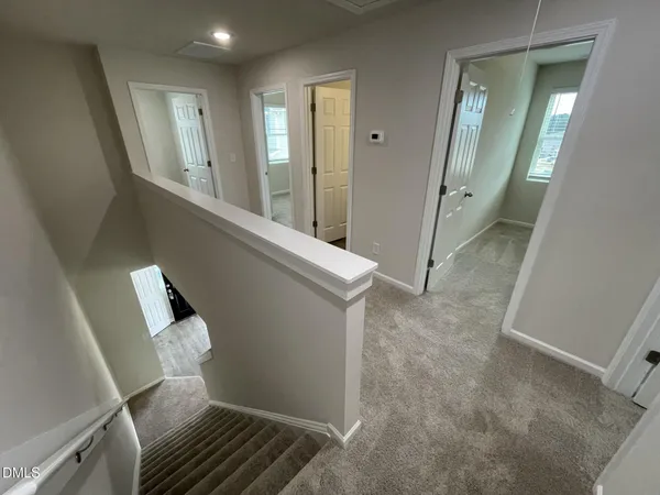 a view of a hallway and a livingroom with furniture