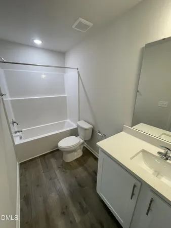 a bathroom with a sink a toilet and a shower