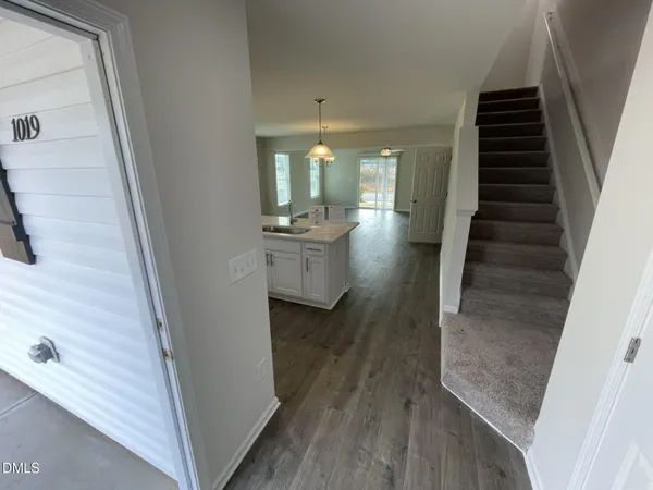 a view of entryway and hall with wooden floor