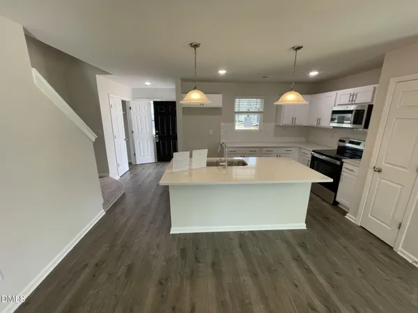 a spacious bathroom with a sink a mirror and bathtub