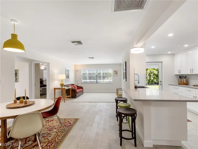 a kitchen with stainless steel appliances granite countertop a stove a sink cabinets and a refrigerator