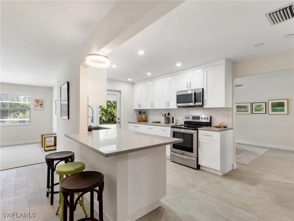 a store room with lots of clutter and cabinets