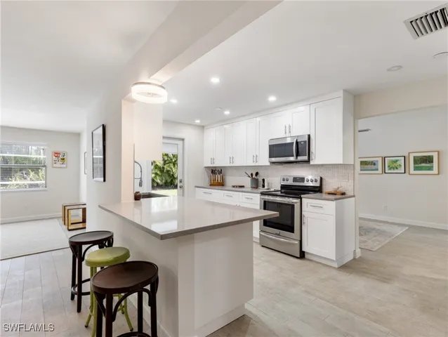 a store room with lots of clutter and cabinets