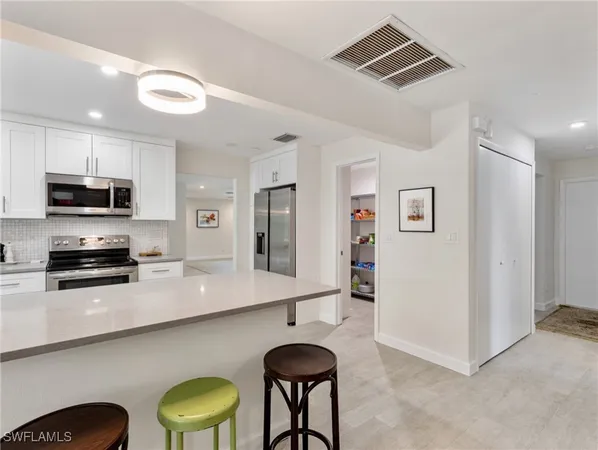 a kitchen with sink a stove and microwave