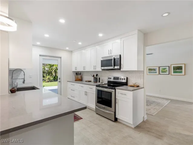 a kitchen with sink and cabinets