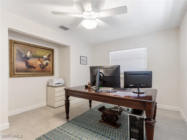 a bedroom with a bed and a ceiling fan