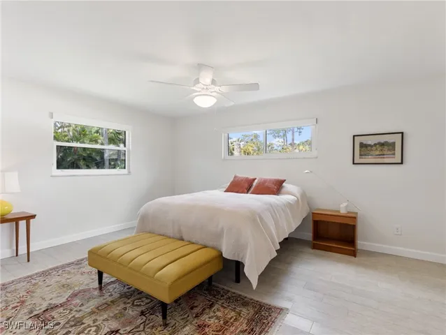 a bathroom with a tub a sink and a large mirror