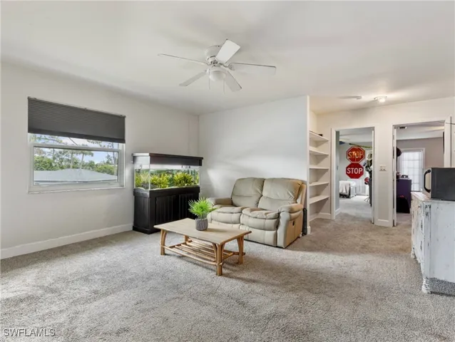 a living room with furniture a window and a flat screen tv