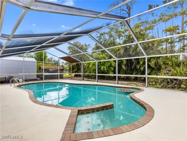 a view of a swimming pool with a porch and yard