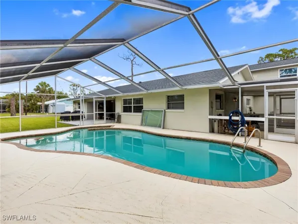 a view of a house with backyard and sitting area