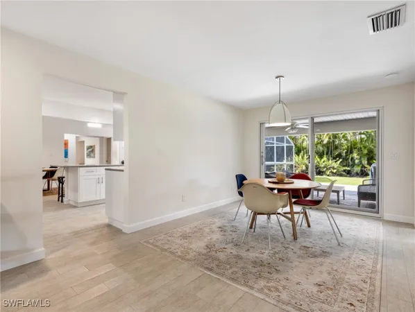 a dining room with furniture a rug and a large window
