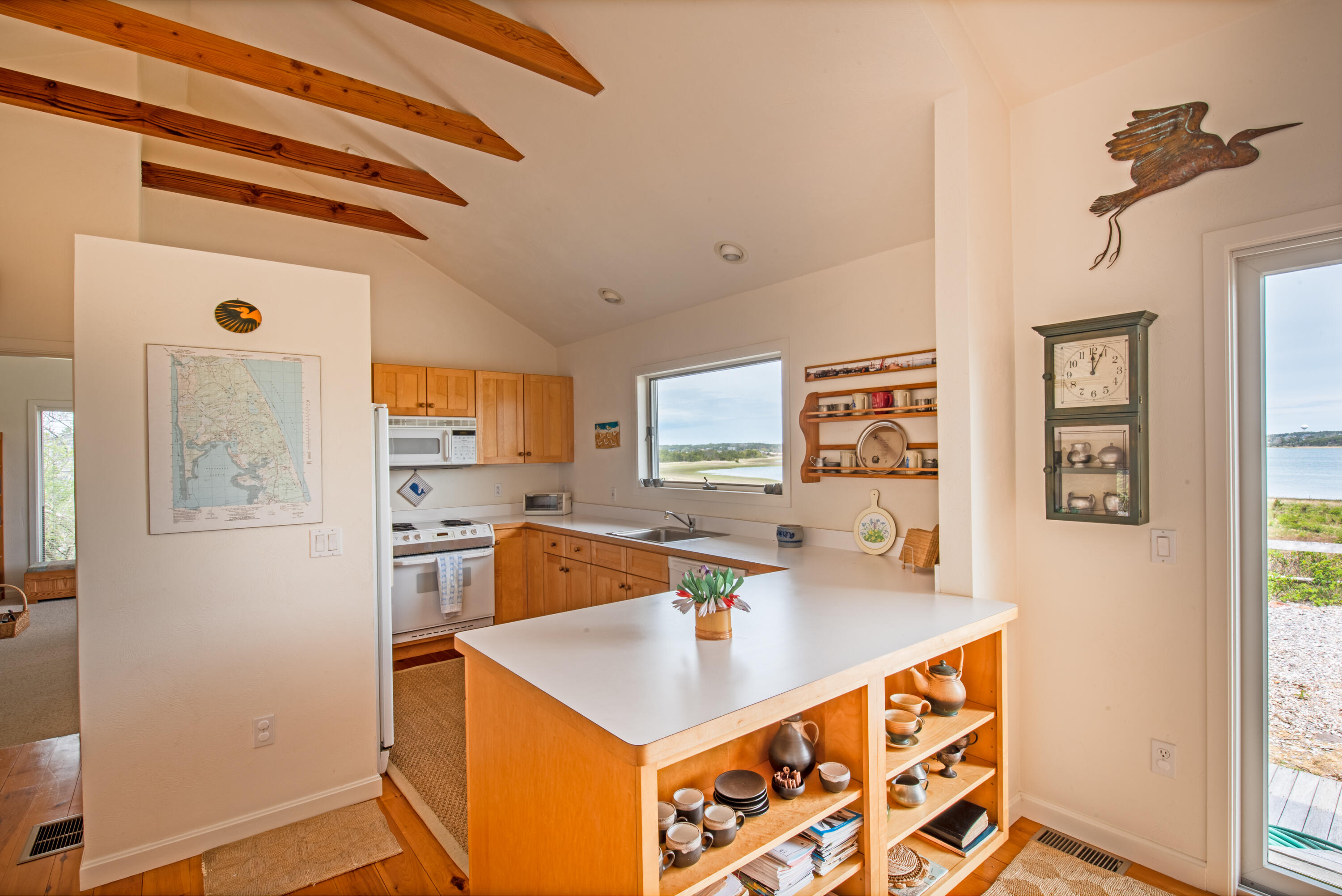 40 Ione Road Wellfleet, MA 02667 - Photo 18 of 30 a kitchen with stainless steel appliances a sink stove and refrigerator