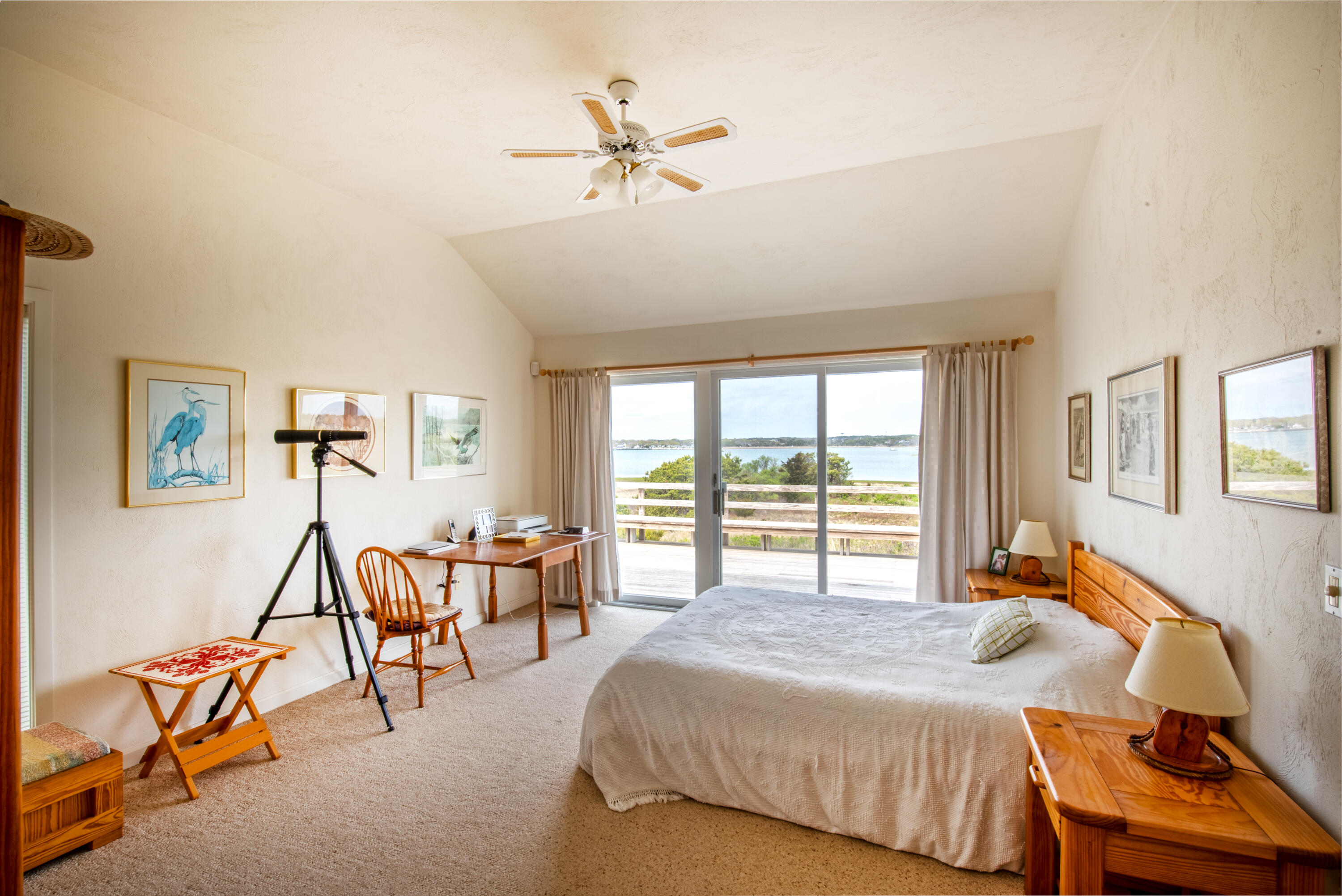 40 Ione Road Wellfleet, MA 02667 - Photo 23 of 30 a bedroom with a bed and a chandelier
