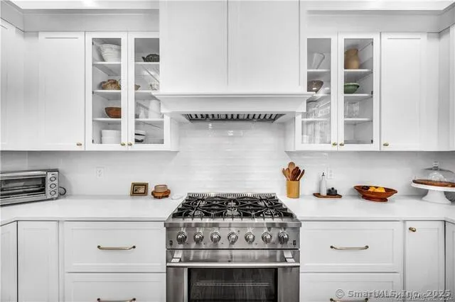 a stove top oven sitting inside of a kitchen