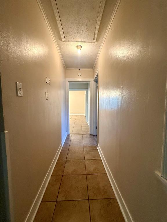 217 3rd St Pinehill Springhill, LA 71075 - Photo 6 of 23 Hallway featuring ceramic tile flooring, light-toned walls, and a ceiling-mounted light fixture