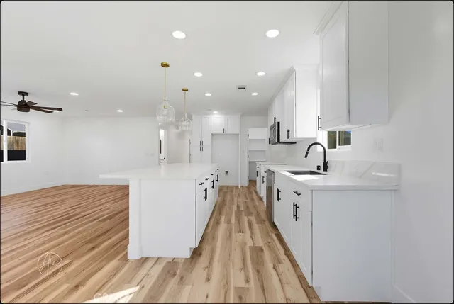 a view of kitchen with sink microwave and stove