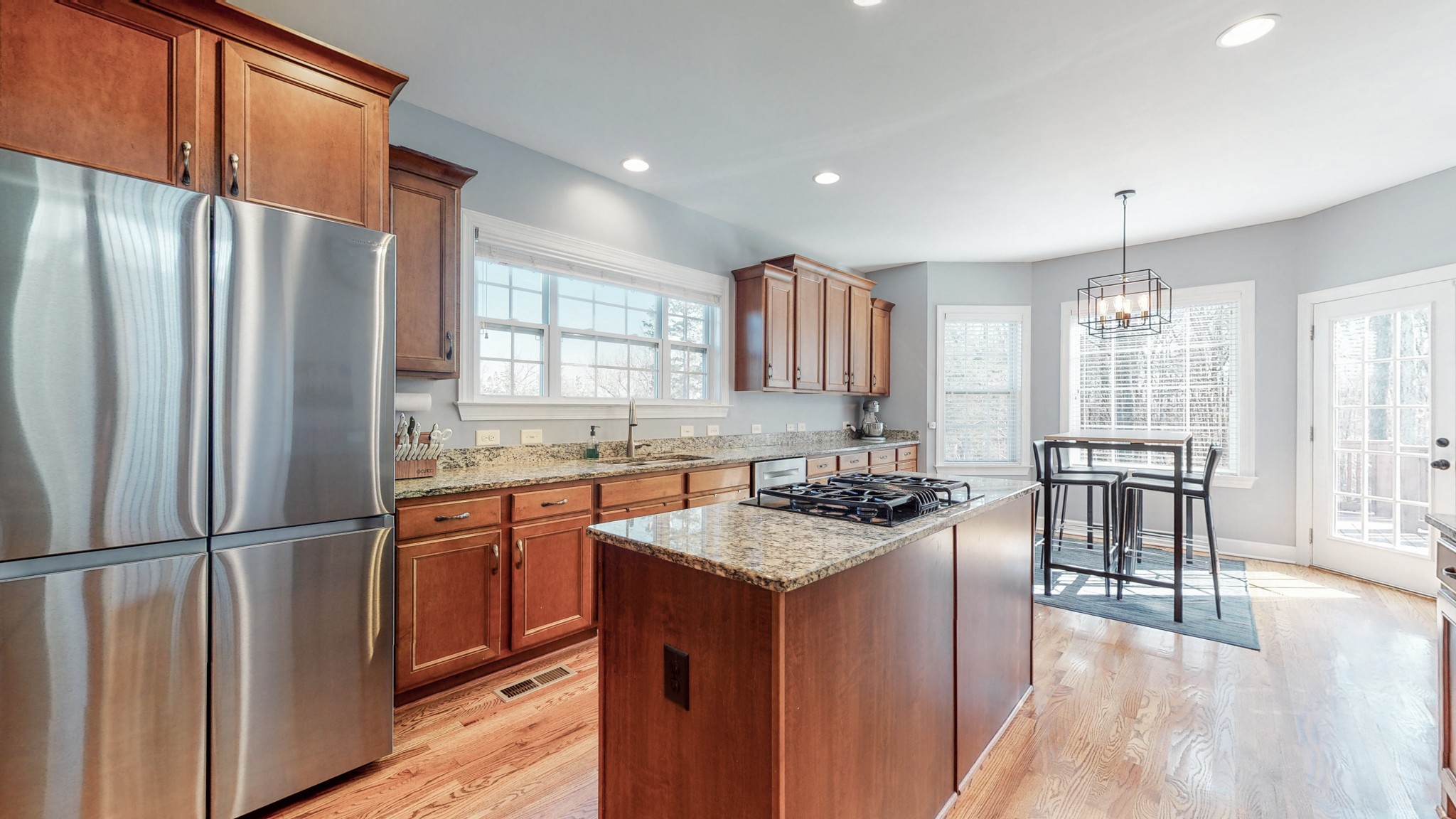 6137 Stags Leap Way Franklin, TN 37064 - Photo 9 of 24 a kitchen with stainless steel appliances granite countertop a refrigerator a sink dishwasher a stove and a refrigerator with wooden floor