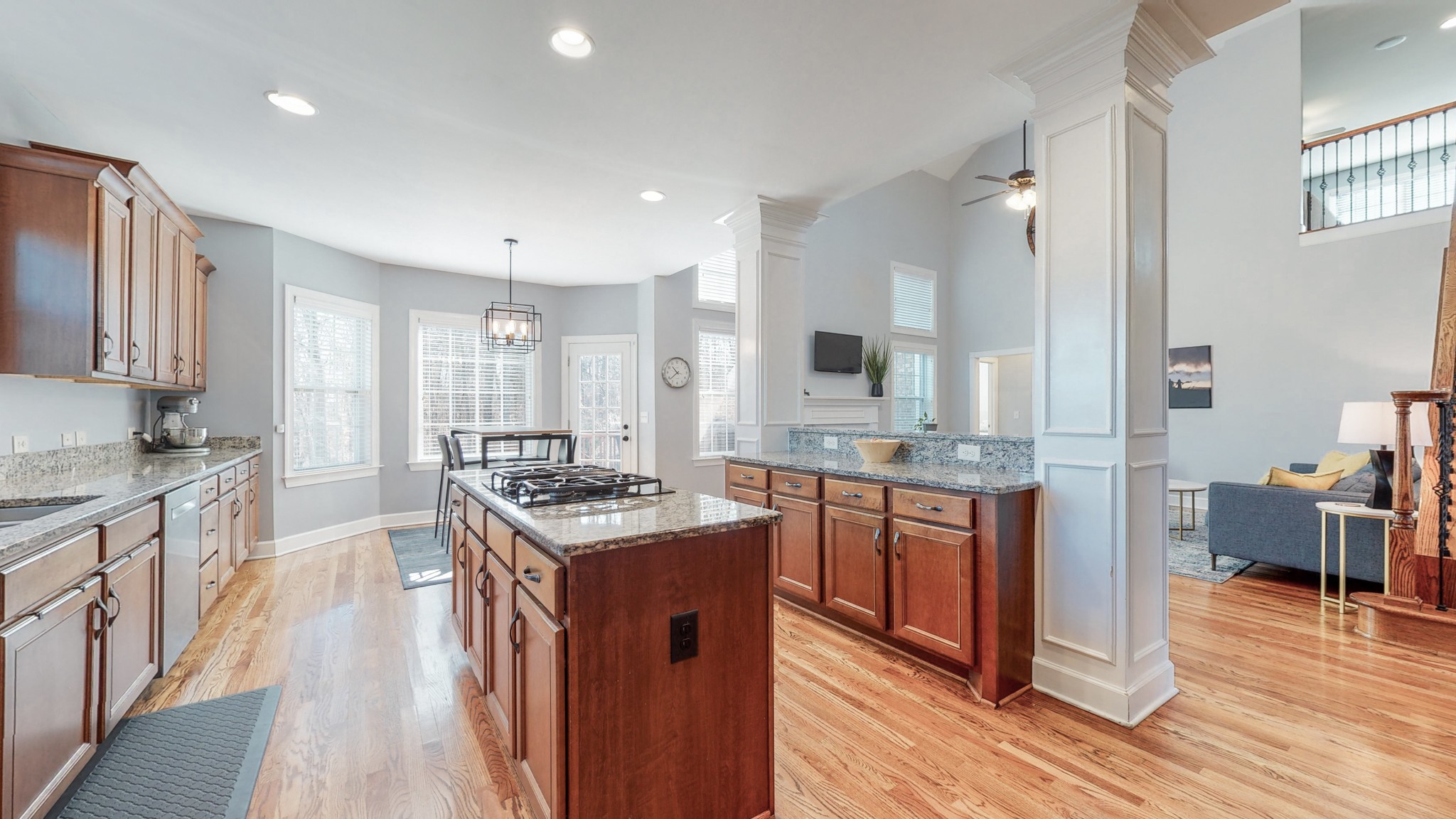 6137 Stags Leap Way Franklin, TN 37064 - Photo 10 of 24 a kitchen with stainless steel appliances granite countertop wooden floors and white cabinets
