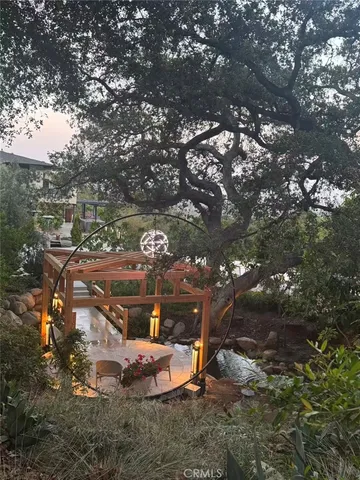 a backyard of a house with table and chairs