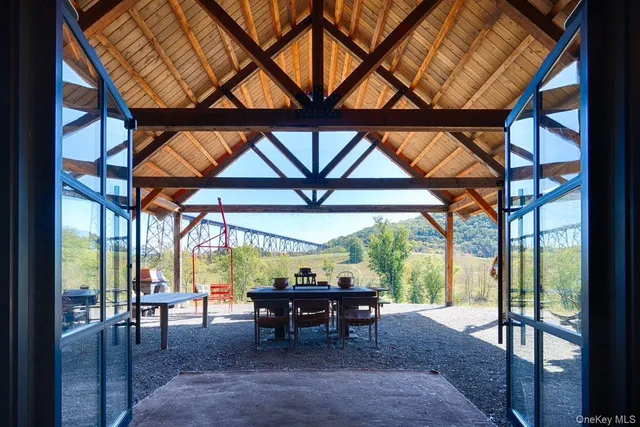 a dining room with furniture and garden view