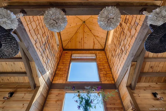 a living room with furniture large window and wooden floor