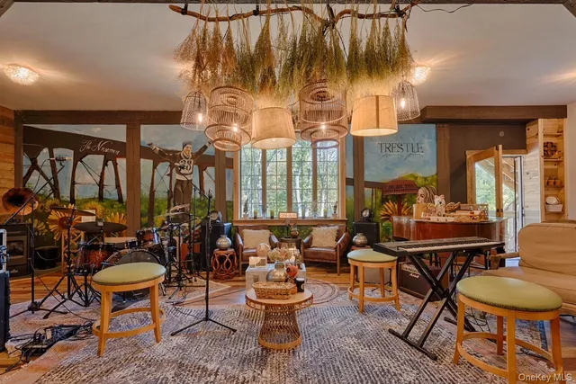 a living room with lots of furniture and a large window